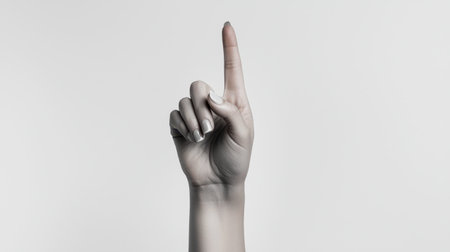 A single hand displaying an upward-pointing index finger against a clean white background. This striking gesture symbolizes direction, positivity, and confidence.の素材