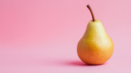 A single ripe pear on a vibrant pink background, showcasing its smooth skin and natural curves. Perfect for themes of health, nutrition, and fresh food.の素材