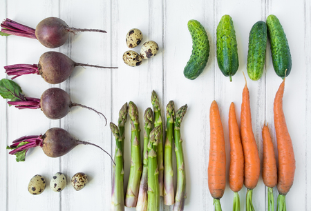 Bright vegetables and eggs knolling composition on white background. Healthy food for salad. Flat lay, top view, view from aboveの写真素材