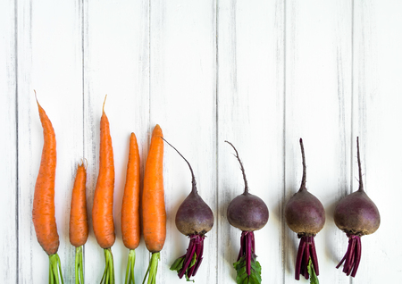 Bright carrots and beetroots: knolling composition on white background. Healthy food for salad. Flat lay, top view, view from aboveの写真素材