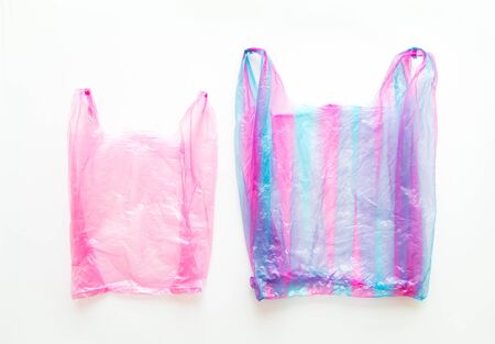 Couple of ugly colorful disposable plastic bags on white background. Reduce, Reuse and Recycle concept. Flat lay, top viewの写真素材