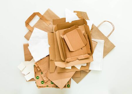 Heap of brown and white eco paper, from used boxes, packages, bags, prepared for recycling. Reduce, Reuse and Recycle concept. Flat lay, view from aboveの写真素材