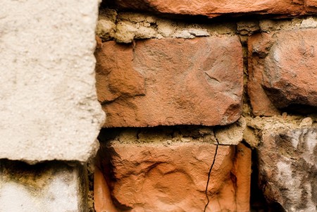old brick building, background crashed stone wall