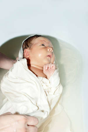 Cute newborn baby in the bath washable.
