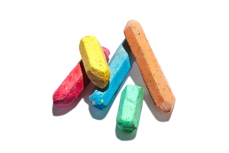 Kids colored chalks on a white background 