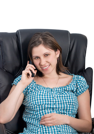Secretary Woman sitting in a chair talking on the phone.の写真素材