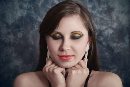 Pretty woman with luxurious earrings. Close-up portrait of fashionの写真素材