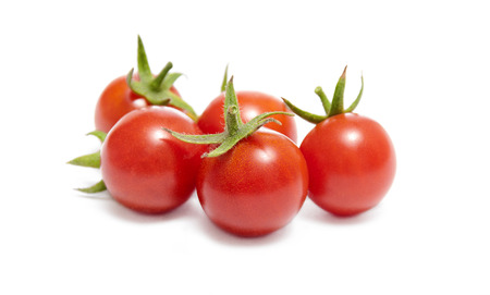 Ripe red cherry tomatoes on white background の写真素材