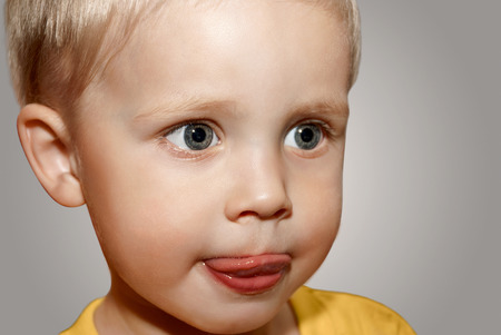 Face little boy on the gray background.の写真素材