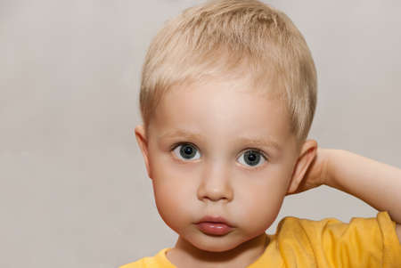 Face little boy on the gray background.の写真素材