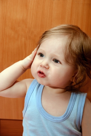 Portrait of a funny little boy in blue shirt.の写真素材