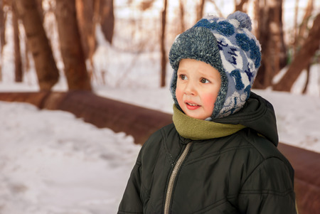 Portrait handsome little boy outdoors in winterの写真素材