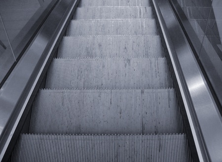 detail photography showing some moving stairs in reflective ambianceの写真素材