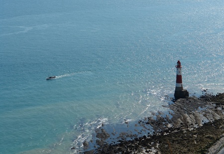 aerial shot of a lighthouse and Boat near Beachy Head in England at summer timeの写真素材
