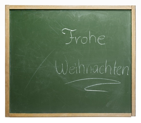 old used blackboard with written "Frohe Weihnachten" on it. Studio photography in white backの写真素材