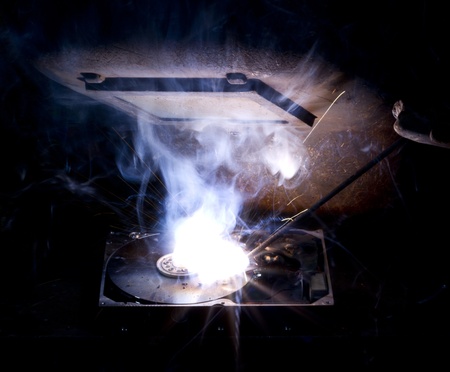 welding scenery with hard disk drive, welding mask detail and flashy light
