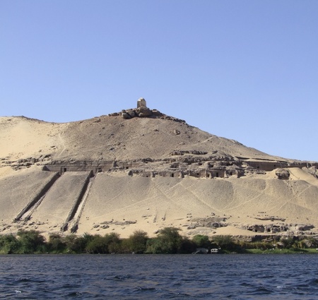 sunny scenery showing a ancient mausoleum on mountain top near Aswan in Egyptの写真素材