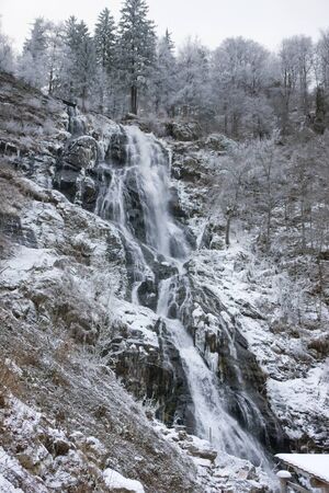 waterfall near Todtnau, a town in the Black Forest in Germany at winter timeの写真素材