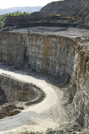 yellow stone pit digger and dump trucks in quarry ambianceの写真素材