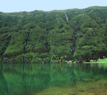 translucent lake and overgrown hills at Sao Miguel Islandの写真素材