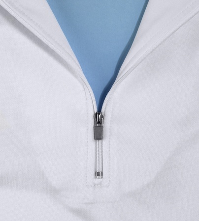 detail of a white shirt with zipper, half openedの写真素材
