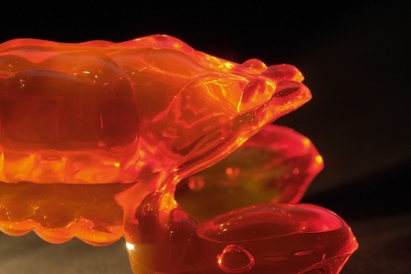 illuminated red transparent massage tool in dark backの写真素材