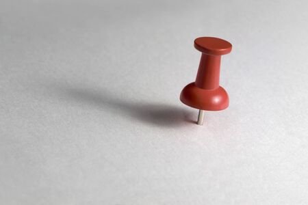 studio photography of a red pin in light paper backの写真素材