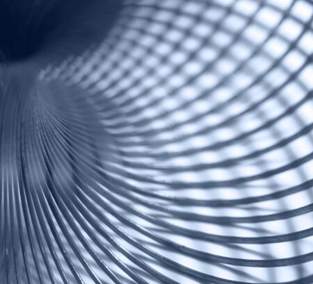 abstract industrial background showing a blue toned detail of a metallic spiral