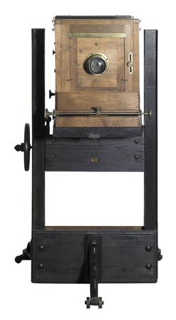 frontal view of a nostalgic wooden camera in white backの写真素材