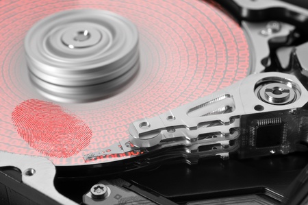 symbolic theme around data security showing a open hard disk with symbolic fingerprint and data