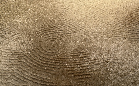 art theme showing a abstract lined owl shape pressed in sand surfaceの写真素材