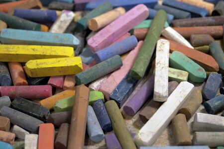 art background with lots of colored pastel crayonsの写真素材