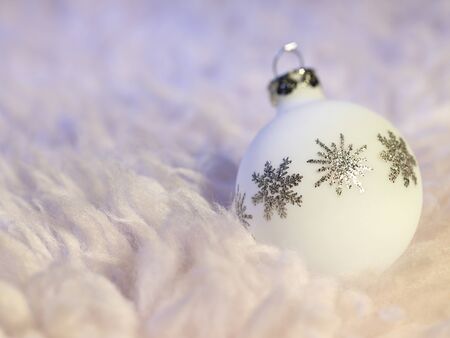 Christmas bauble with metallic ornaments in fluffy backの写真素材