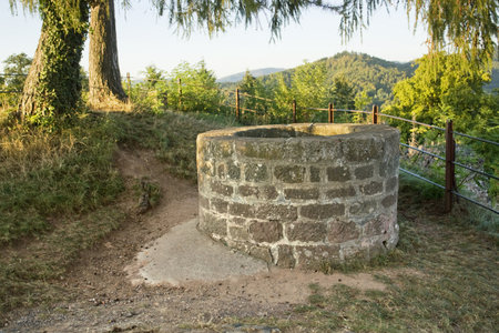 idyllic scenery around the "Hochburg Emmendingen" in Southern Germany with historic well made of stone, sunny illuminated at evening timeのeditorial素材