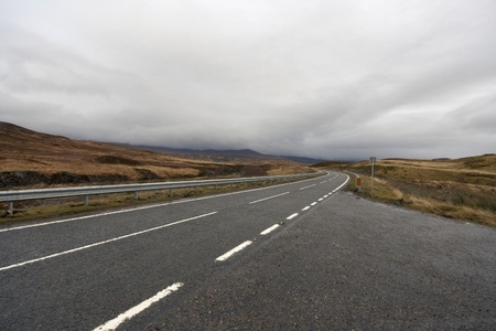roadside scenery near Ullapool in Scotland with dramatic sky at autumn timeの写真素材