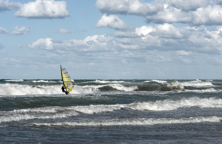 a windsurfer on wavy sea in Southern Italyの写真素材
