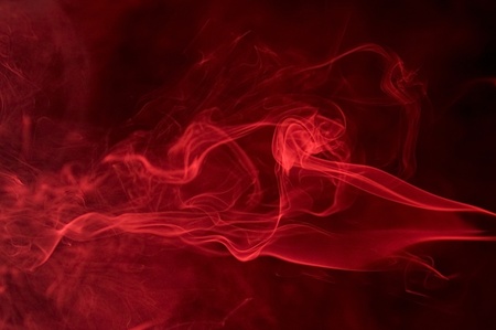 abstract background showing some red smoke in black backの写真素材