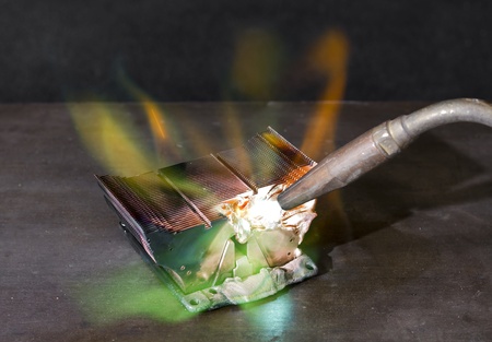 melting heat sink and welding torch on metallic groundの写真素材