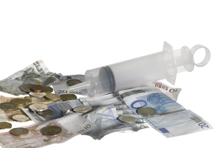 symbolic financial crisis theme with a big syringe filled with euro money, isolated on whiteの写真素材