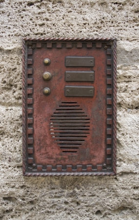 historic doorbell plate on rough facade, seen in Italyの写真素材