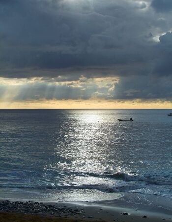 cloudy coastal scenery on a caribbean island named Guadeloupe at evening timeの写真素材