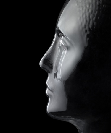 translucent reflective human head made of glass in black backの写真素材