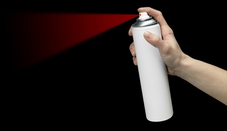 human hand holding a unlabeled white aerosol can with red spray in black back
