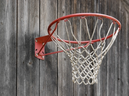 a basketball basket on weathered wooden facadeの写真素材