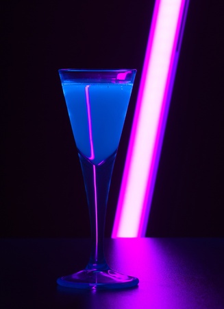a fluorescent illuminated drink in dark backの写真素材