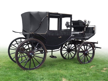 black historic carriage on green grass, gradient isolated on whiteの写真素材