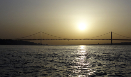 distant shot of the Vasco da Gama Bridge near Lisbon in Portugal at evening timeの写真素材