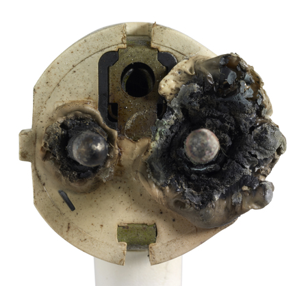 a burnt power plug in white backの写真素材