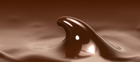 full frame detail of liquid brown chocolate with spikeの写真素材