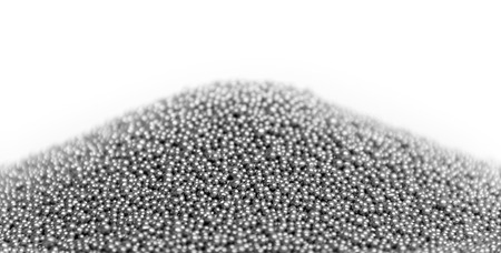 pile of silver metallic beadlets in white backの写真素材